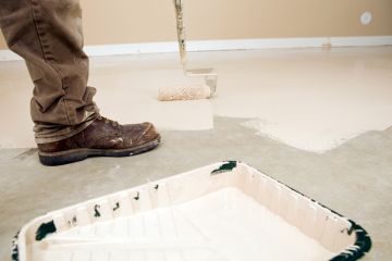 Painter painting garage floor in Fredon Township